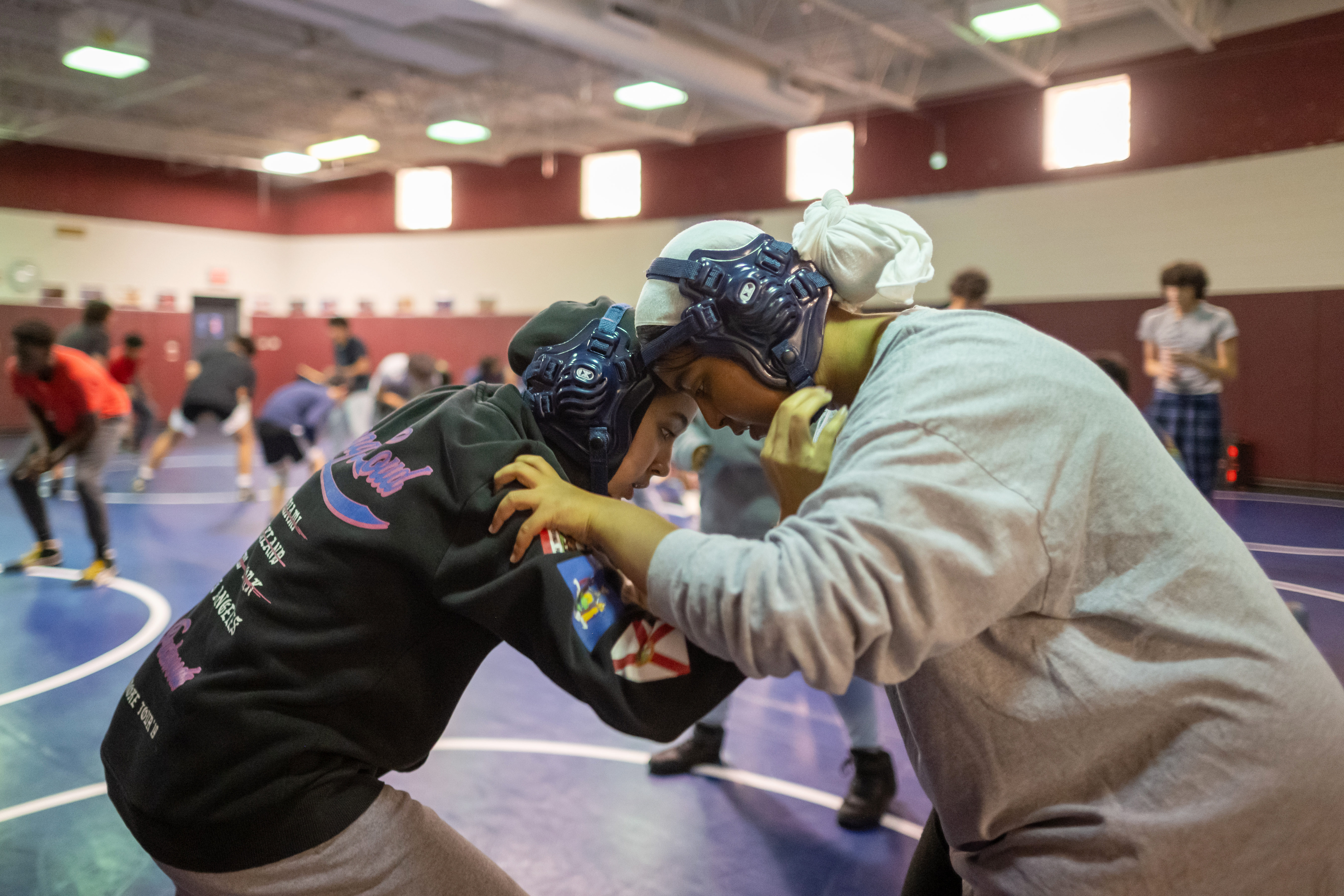 Alae Houmane, left, practices in the ring during wrestling tryouts.